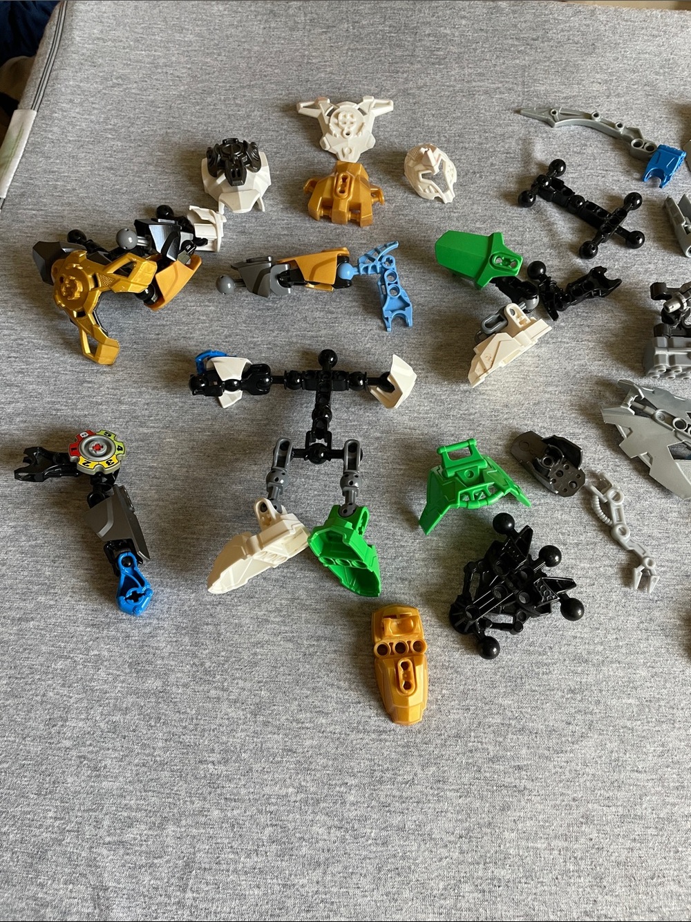 Assorted Green, Gold, White and Black Building Toy Parts(some parts are missing)